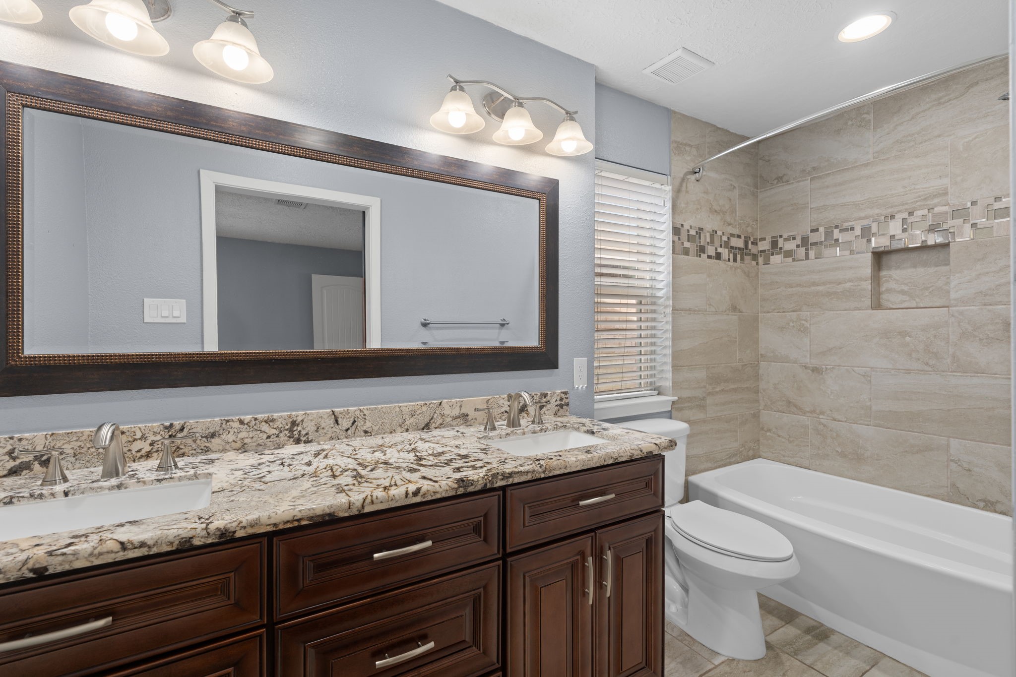 2622 Strait Lane Houston, TX 77084 - Photo 23 of 47 a bathroom with a granite countertop sink toilet and shower