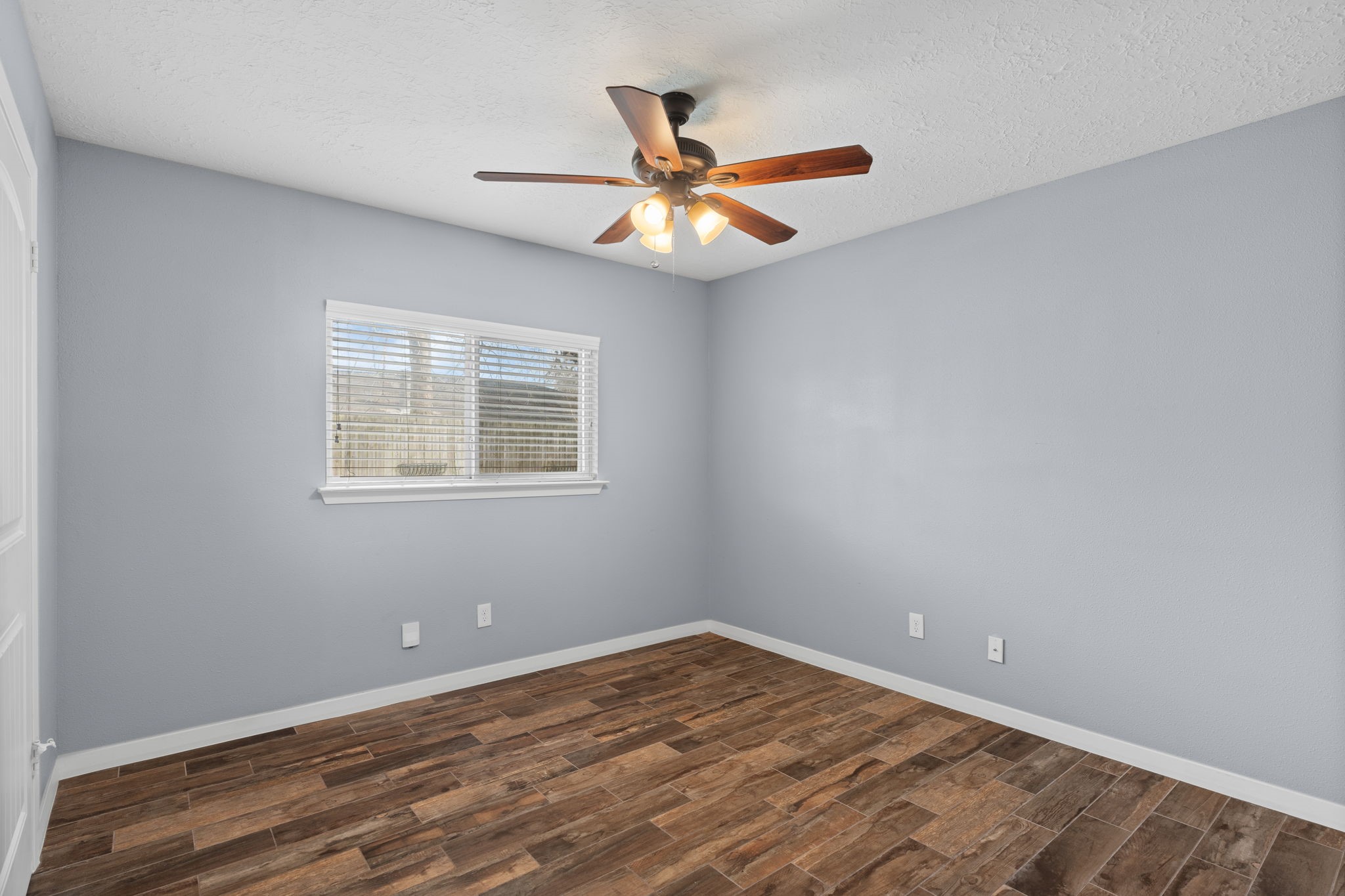 2622 Strait Lane Houston, TX 77084 - Photo 27 of 47 an empty room with a window and a ceiling fan