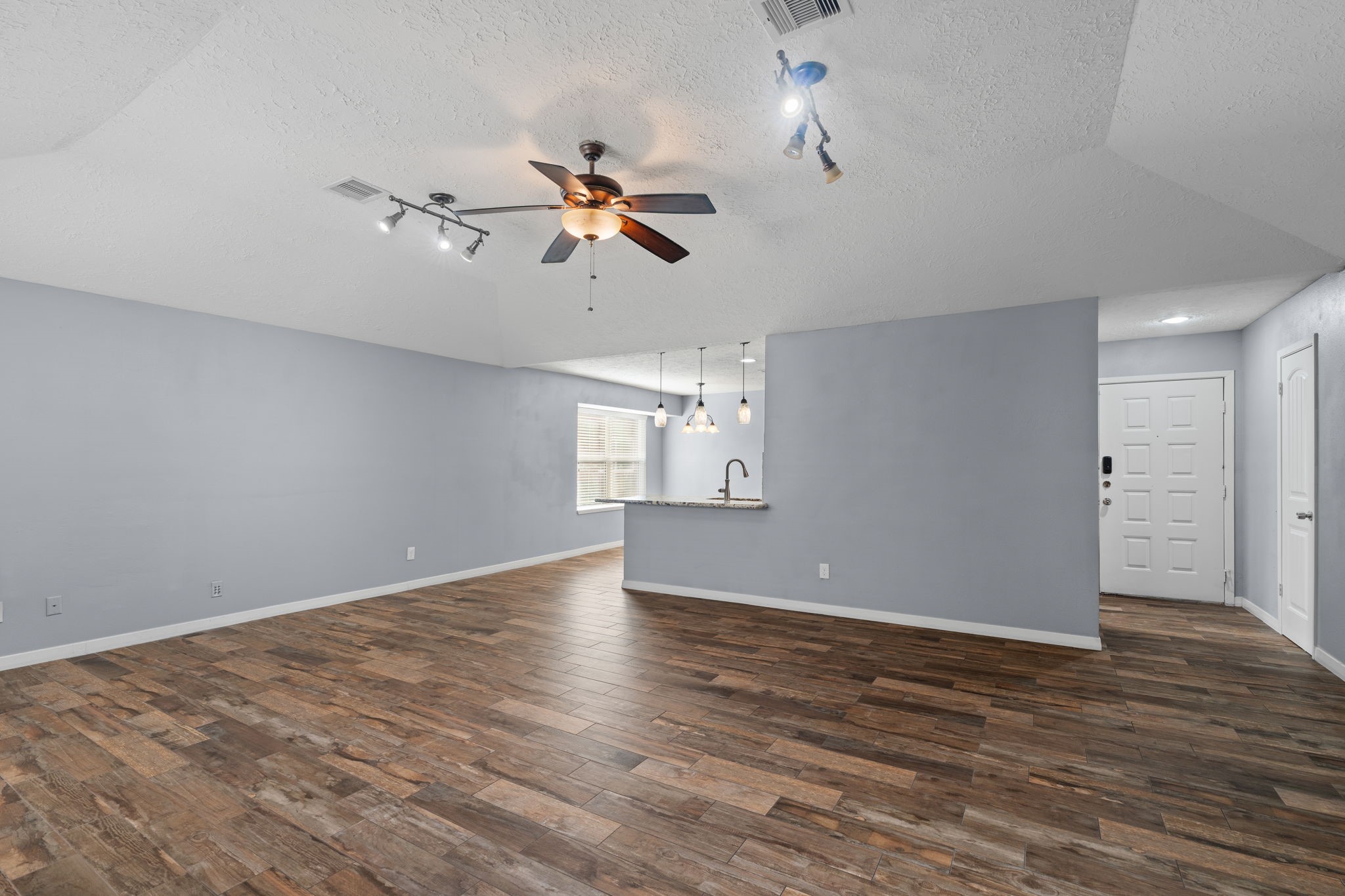 2622 Strait Lane Houston, TX 77084 - Photo 3 of 47 a view of empty room with wooden floor and ceiling fan
