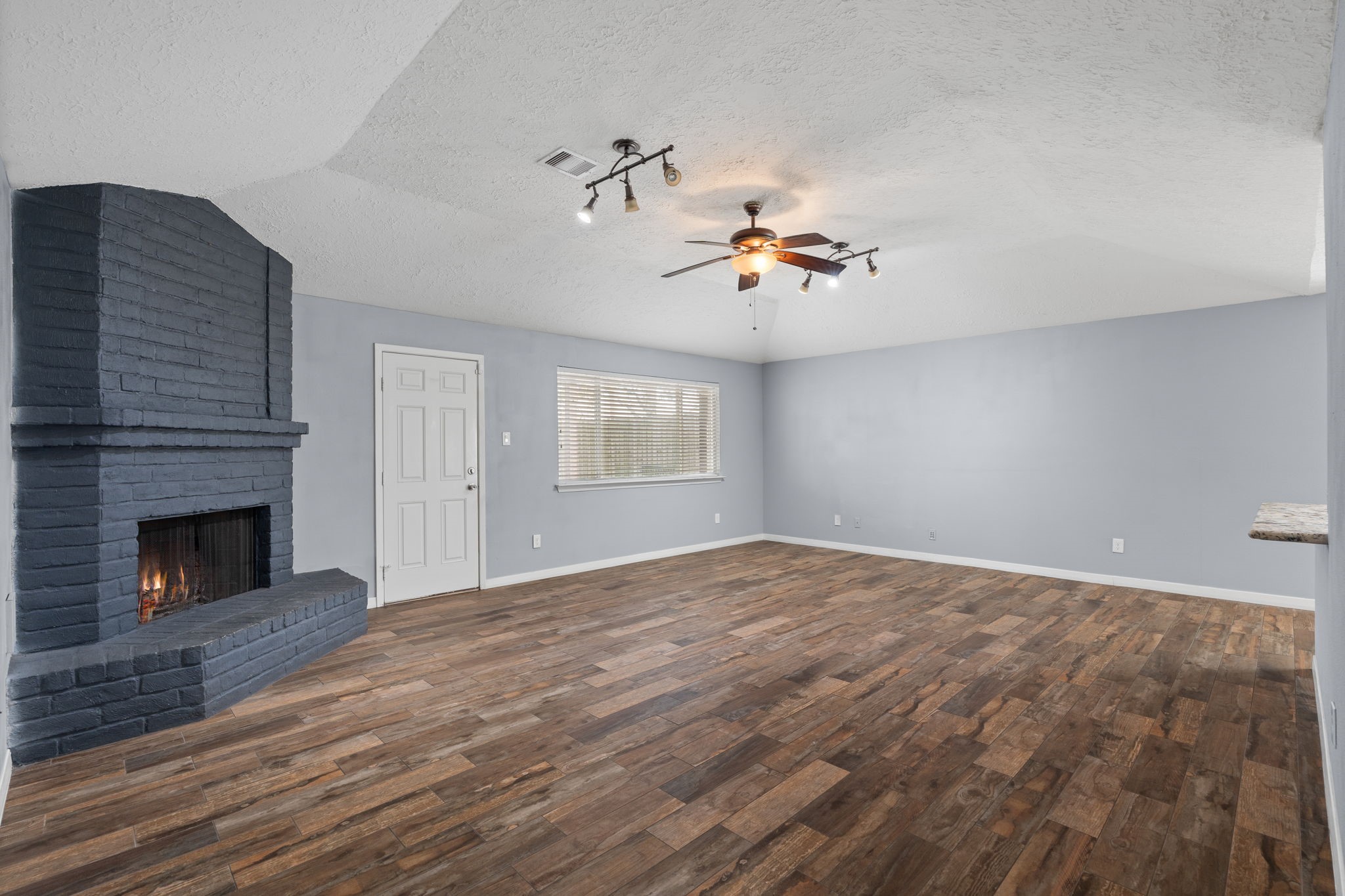 2622 Strait Lane Houston, TX 77084 - Photo 4 of 47 a view of an empty room with a fireplace and a window