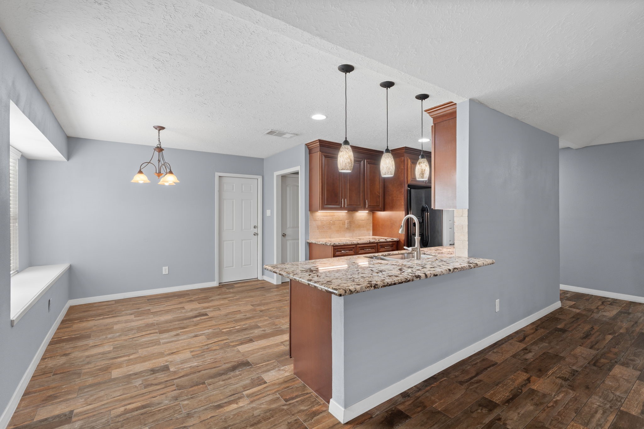 2622 Strait Lane Houston, TX 77084 - Photo 6 of 47 a view of a kitchen with a sink dishwasher a refrigerator and wooden floor