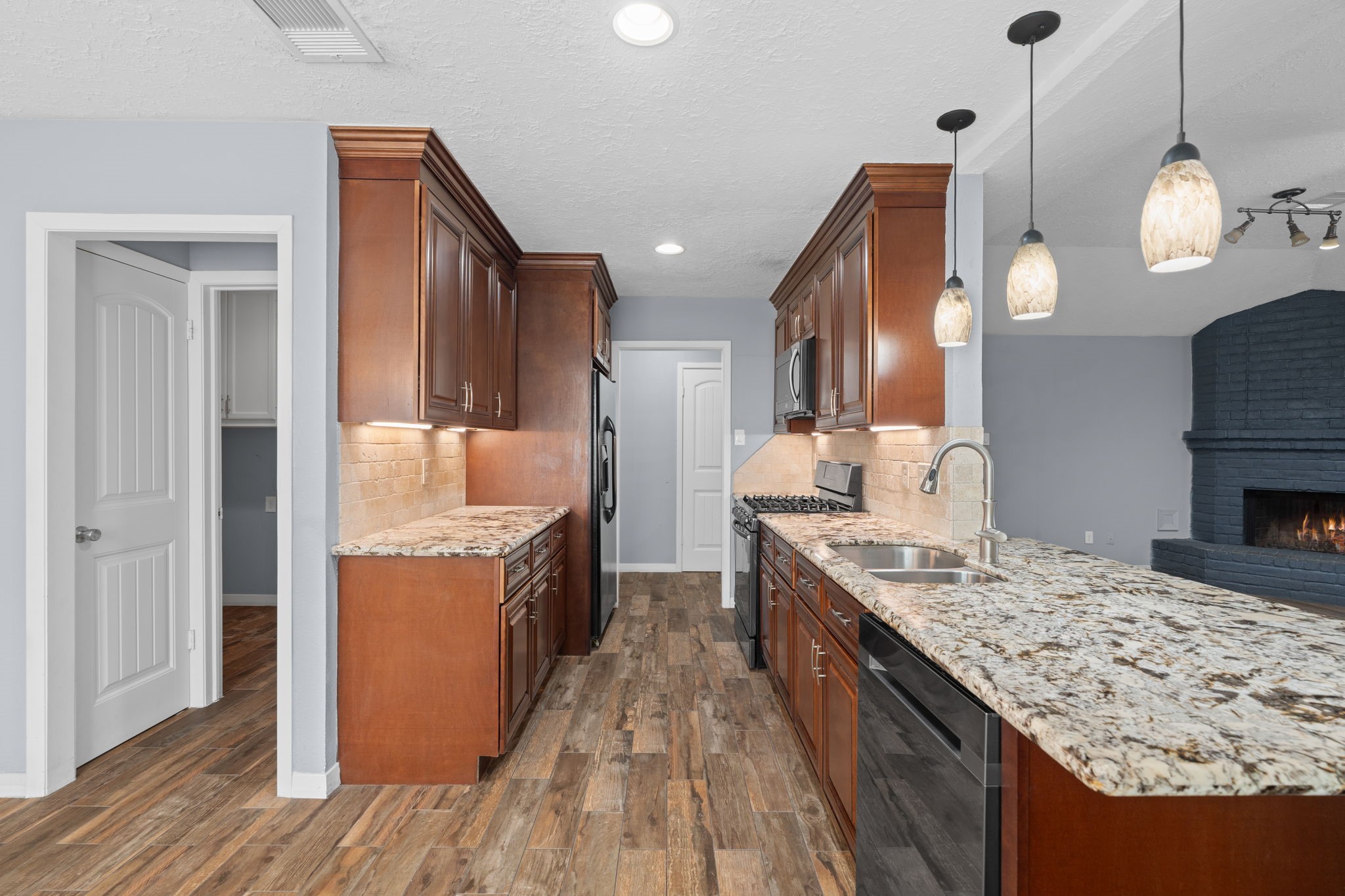 2622 Strait Lane Houston, TX 77084 - Photo 7 of 47 a large kitchen with stainless steel appliances granite countertop a sink a stove and a wooden floors