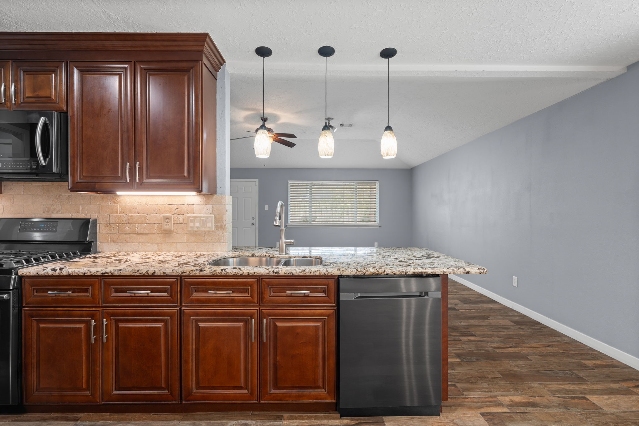 2622 Strait Lane Houston, TX 77084 - Photo 8 of 47 a kitchen with granite countertop cabinets and wooden floor