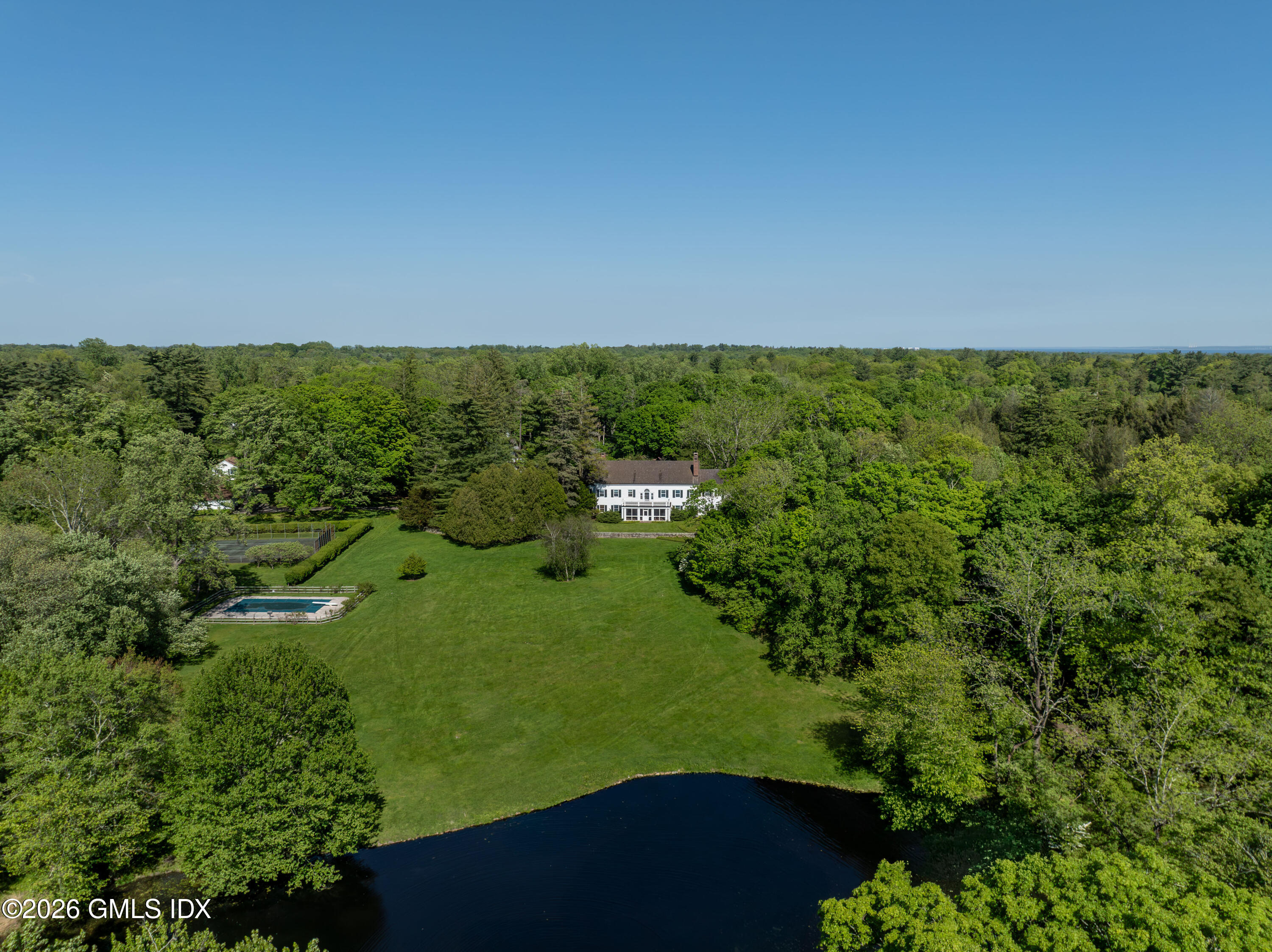 122 Round Hill Road Greenwich, CT 06831 - Photo 18 of 37 a view of a yard with plants and large trees