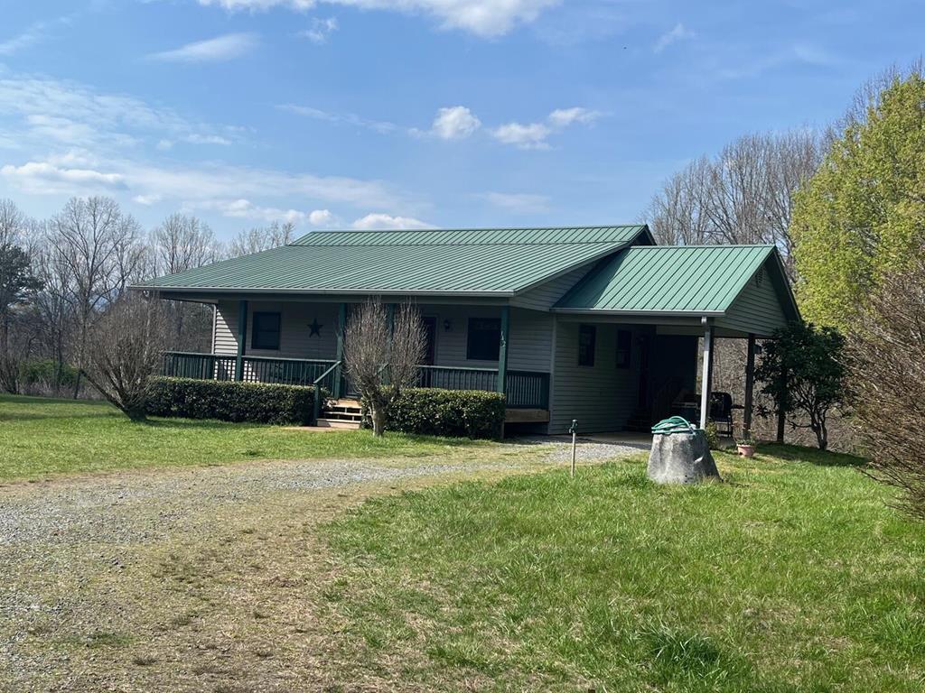 142 Arrowhead Trail Hayesville, NC 28904 - Photo 2 of 41 a front view of a house with garden