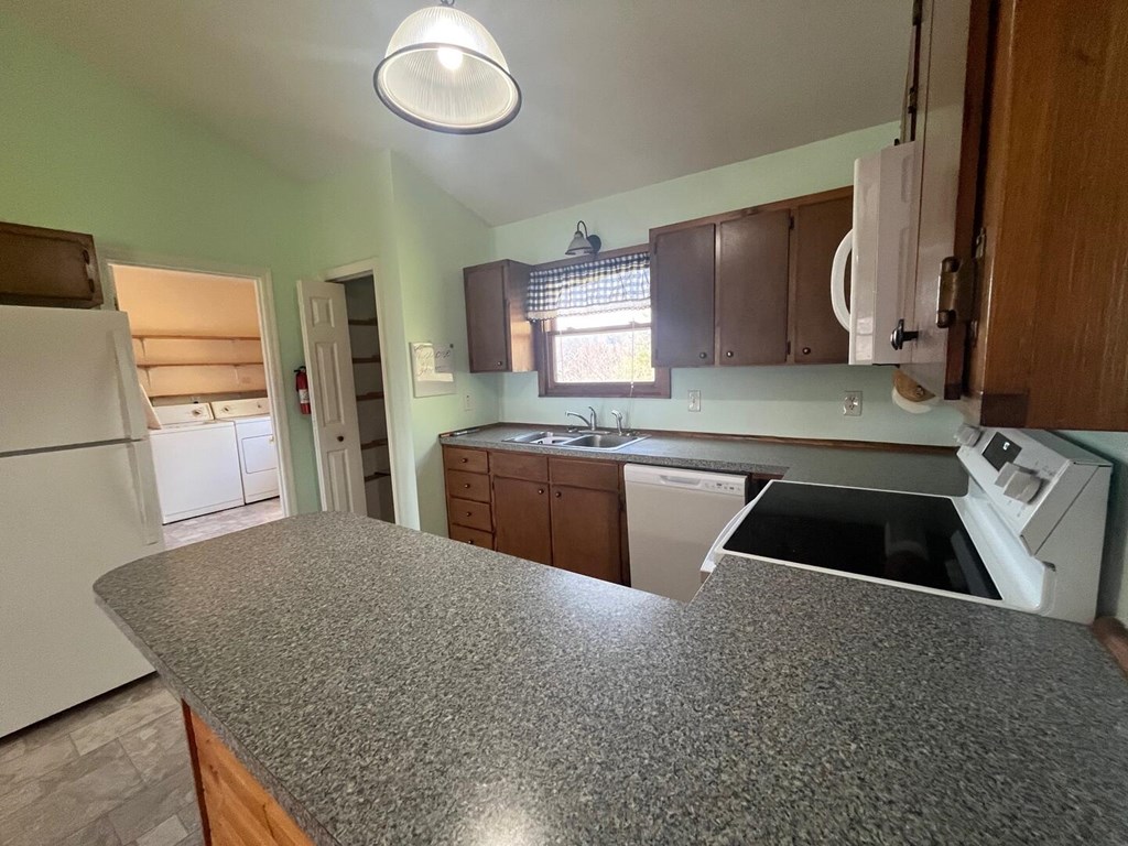 142 Arrowhead Trail Hayesville, NC 28904 - Photo 8 of 41 a kitchen with granite countertop a sink and a stove top oven
