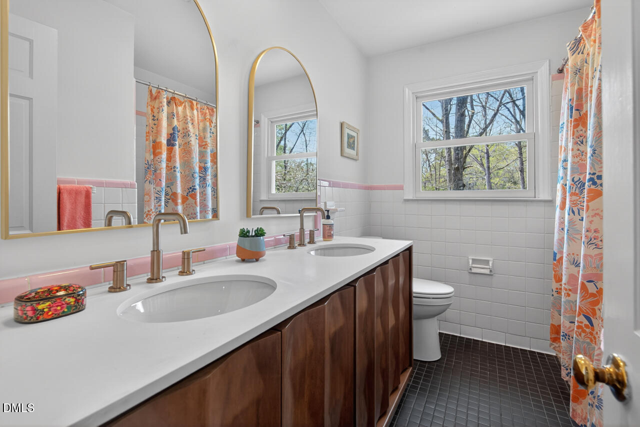 2734 Spencer Street Durham, NC 27705 - Photo 45 of 61 a bathroom with a sink and a mirror