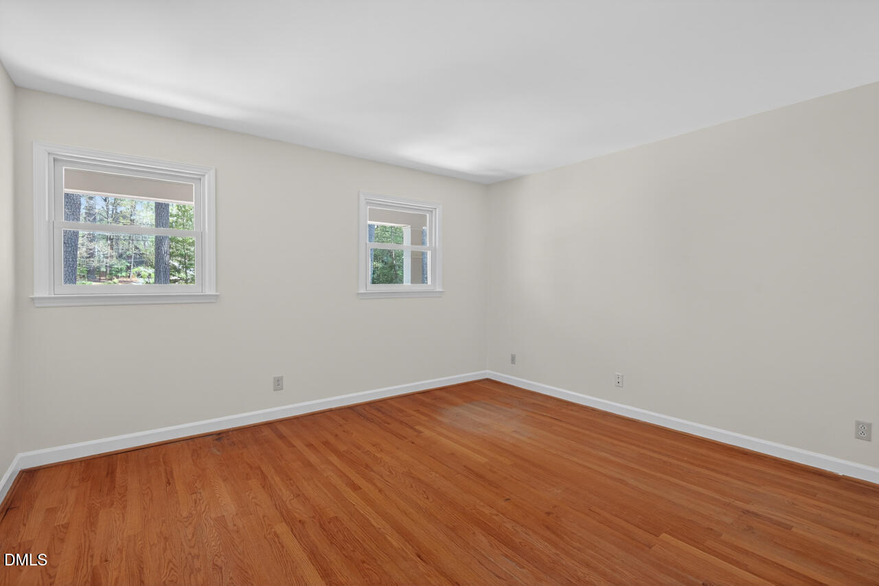 2734 Spencer Street Durham, NC 27705 - Photo 48 of 61 a view of an empty room with wooden floor and a window