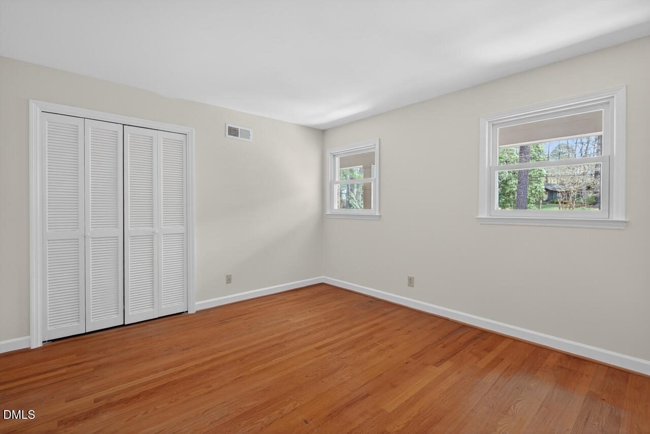 2734 Spencer Street Durham, NC 27705 - Photo 49 of 61 a view of an empty room with wooden floor and a window