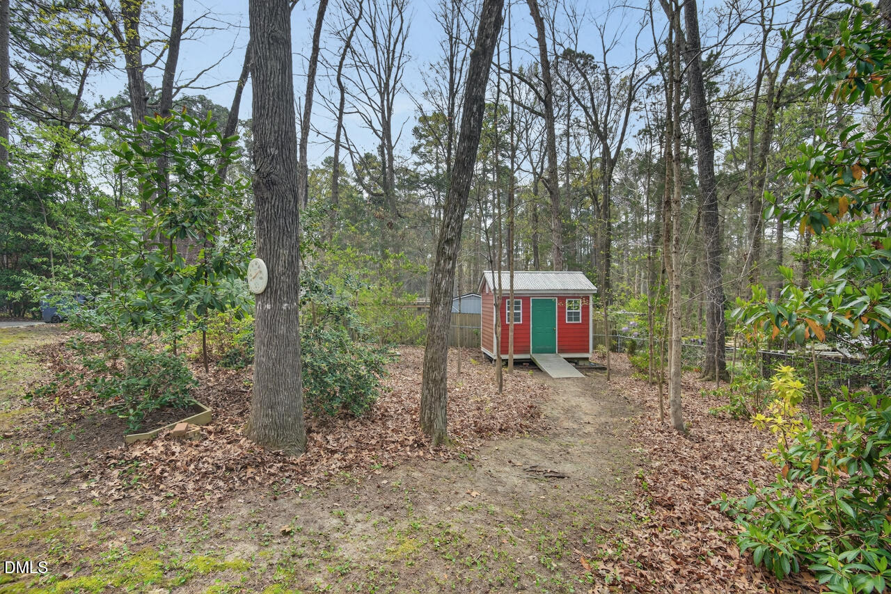 2734 Spencer Street Durham, NC 27705 - Photo 55 of 61 a view of a house with a yard and trees