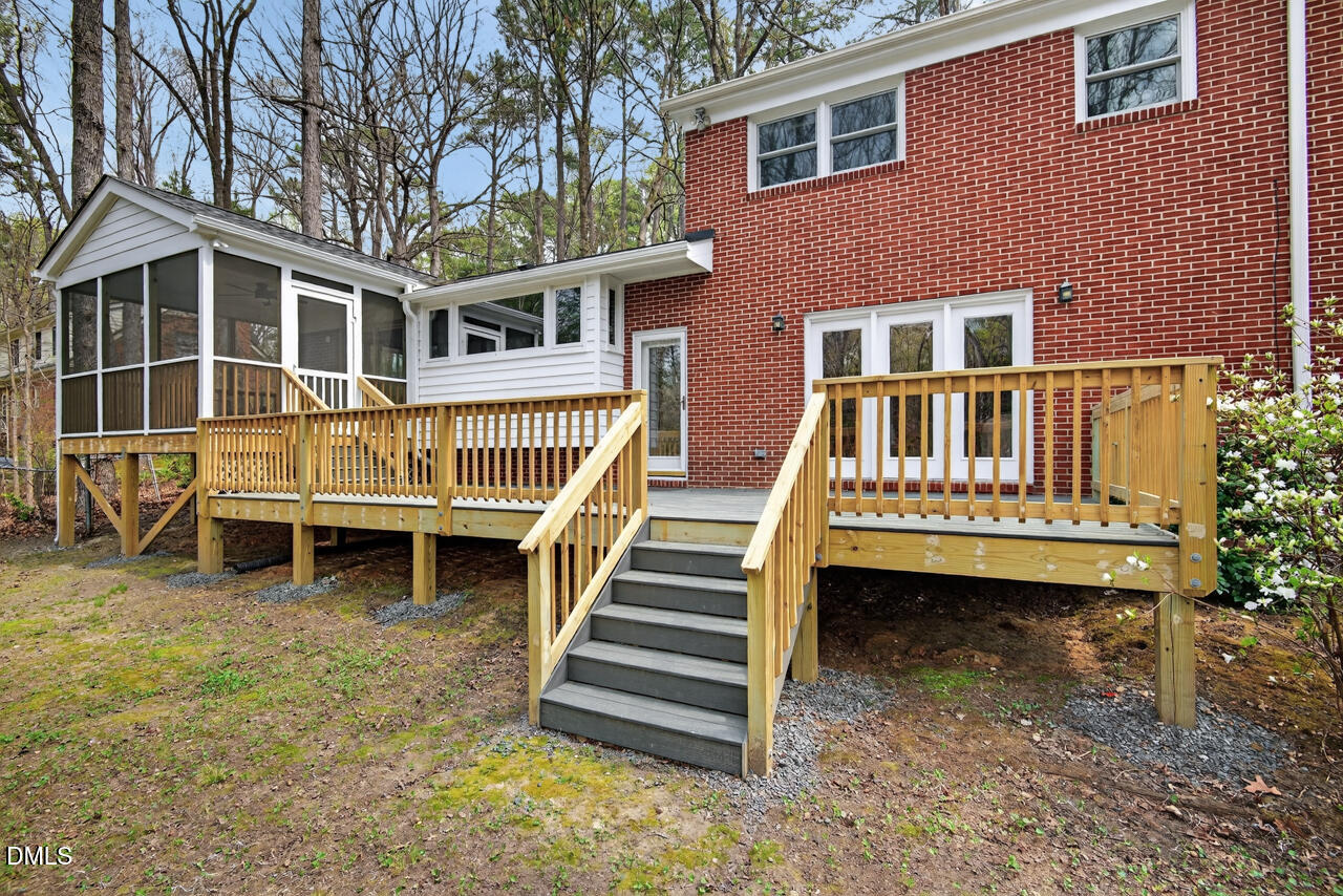 2734 Spencer Street Durham, NC 27705 - Photo 56 of 61 a view of a house with a yard and wooden deck