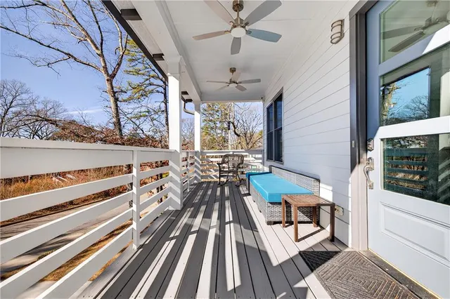 a view of a living room with a rug and wooden floor