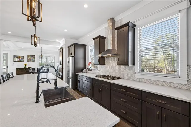 a kitchen with stainless steel appliances a sink a stove and a refrigerator
