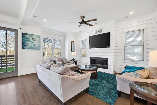 a living room with furniture a fireplace and a flat screen tv