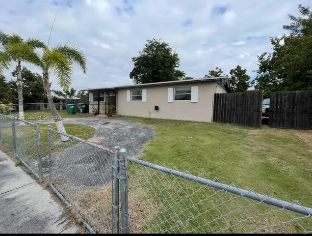 a house view with a backyard space