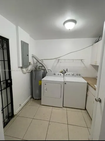 a utility room with cabinets