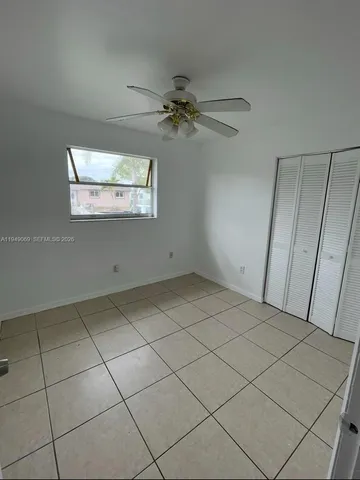 a view of a livingroom with an empty space and a ceiling fan
