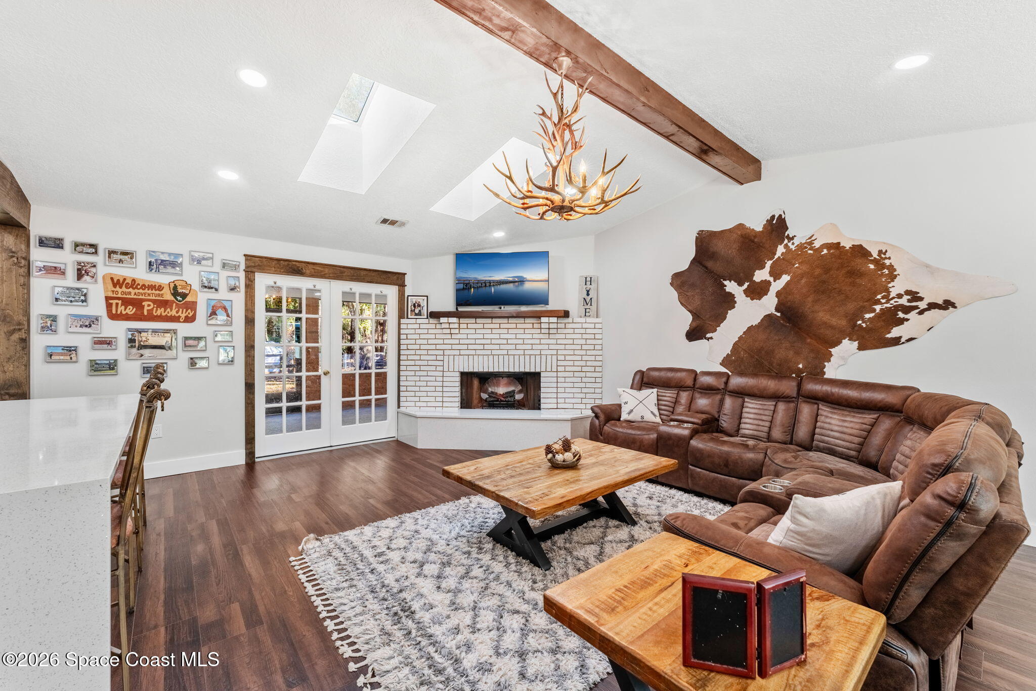3975 Corey Road Malabar, FL 32950 - Photo 23 of 53 a living room with furniture wooden floor and a fireplace