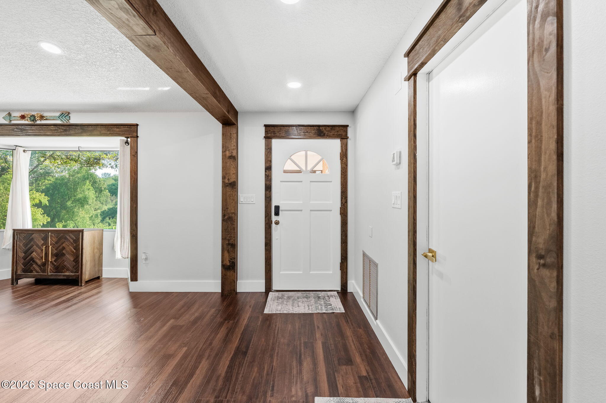 3975 Corey Road Malabar, FL 32950 - Photo 24 of 53 a view of a hallway with wooden floor and windows