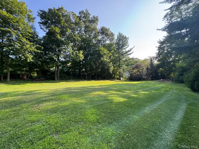 a view of swimming pool is middle in the grass