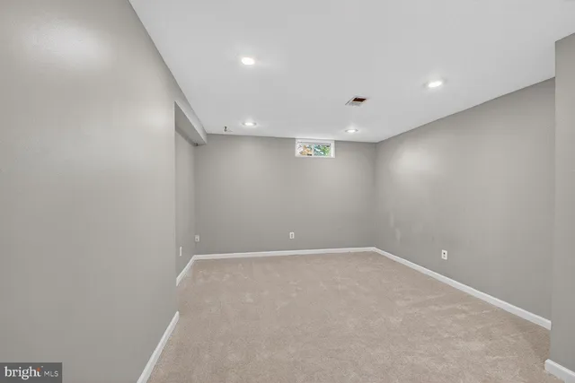a bathroom with a toilet sink vanity tub and mirror