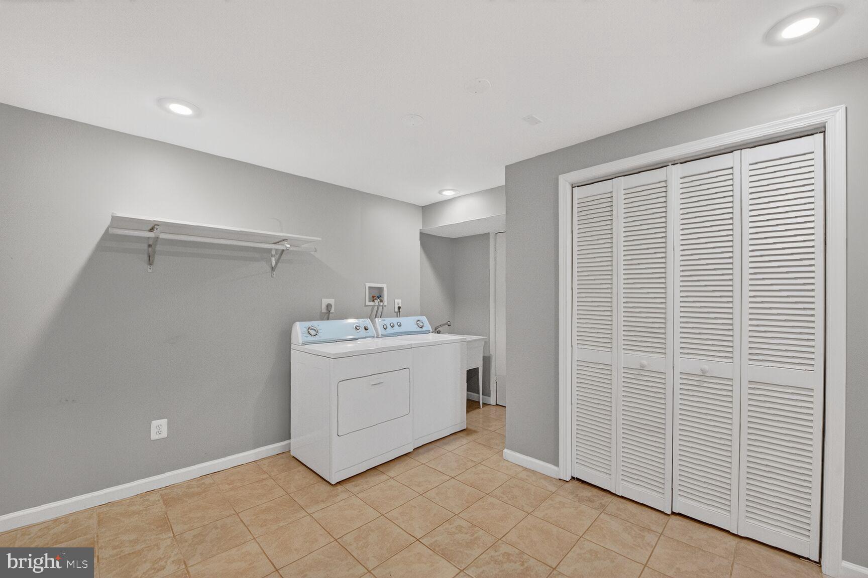 14 Braxton Drive Sterling, VA 20165 - Photo 22 of 28 a utility room with cabinets washer and dryer