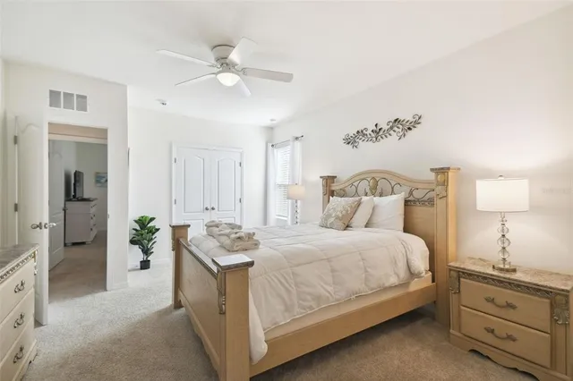 a bedroom with a bed and a flat tv screen on dresser