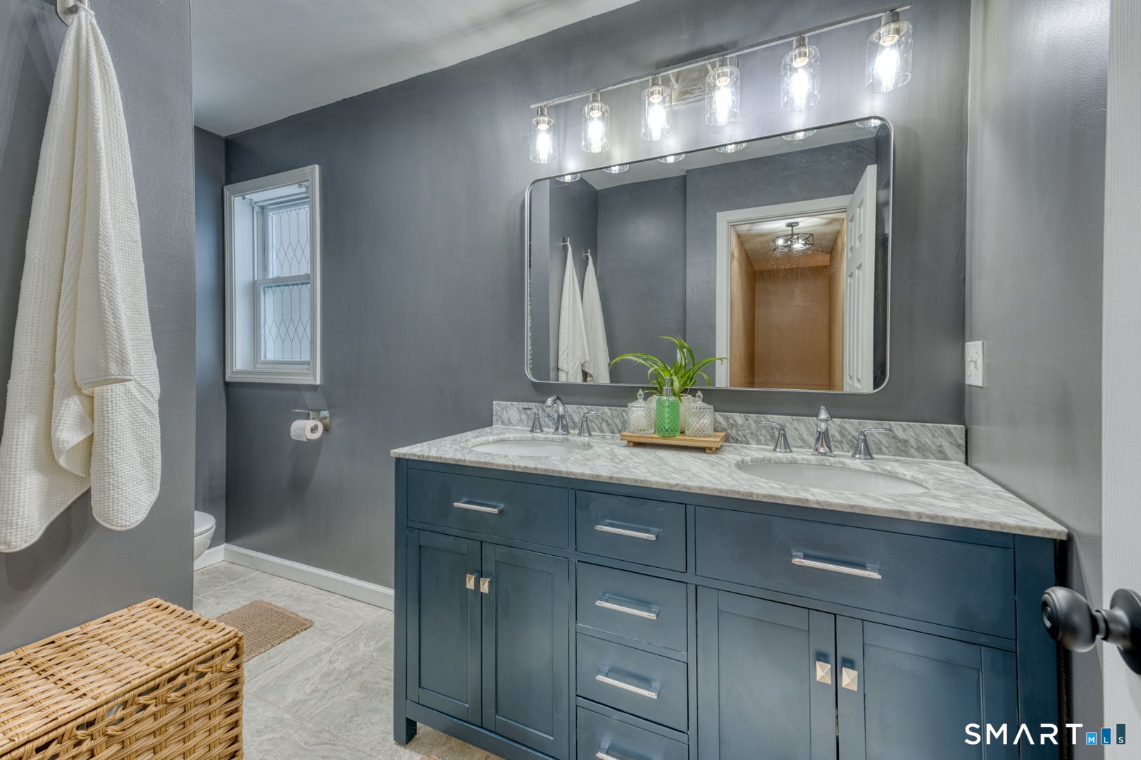1-3 Young Street East Hampton, CT 06424 - Photo 22 of 36 a bathroom with a double vanity sink and a mirror