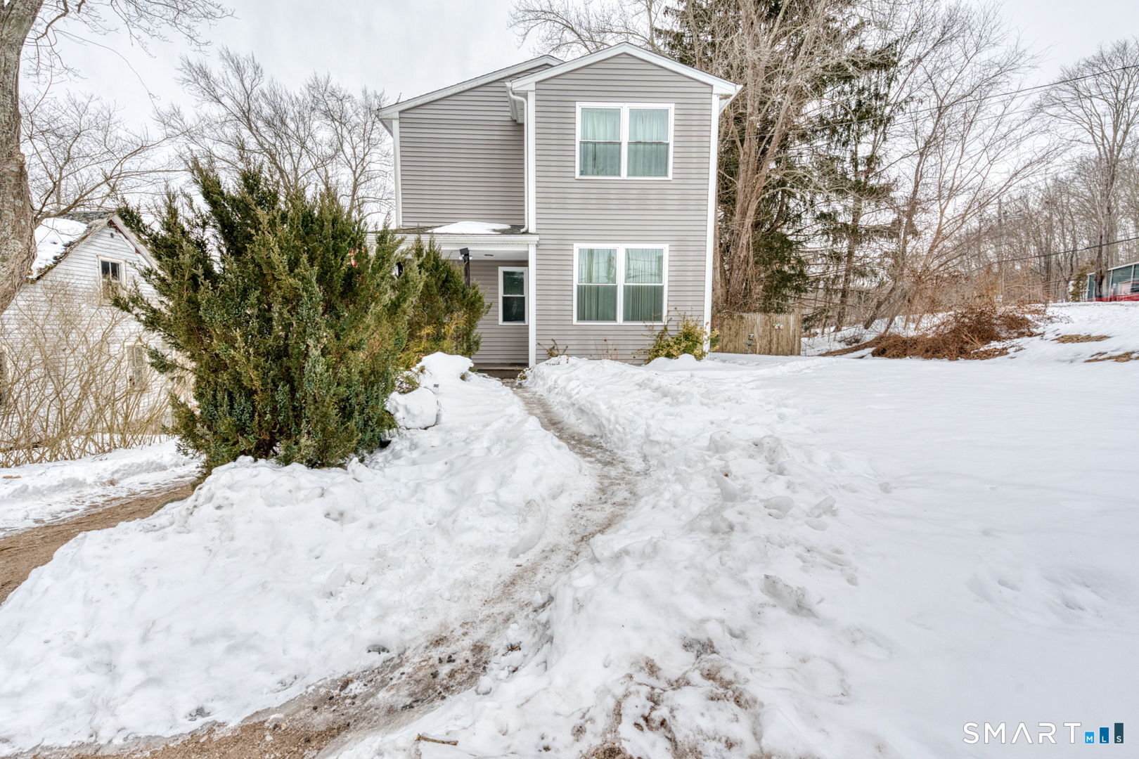 1-3 Young Street East Hampton, CT 06424 - Photo 27 of 36 a view of a white house with a yard covered in snow