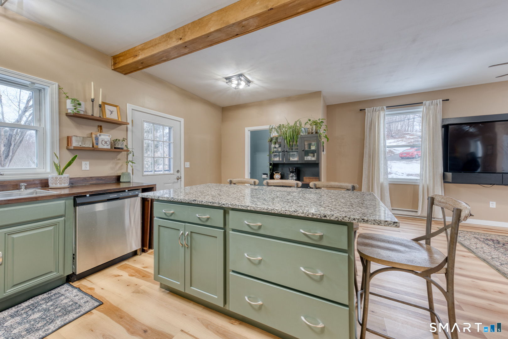 1-3 Young Street East Hampton, CT 06424 - Photo 5 of 36 a kitchen with granite countertop cabinets and flat screen tv