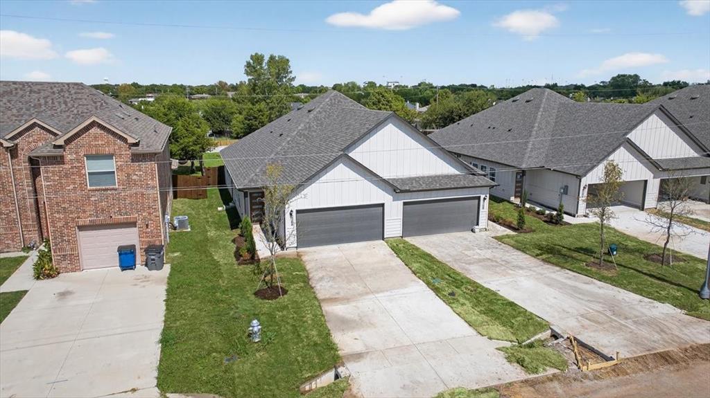 122 Wood Street, Unit A Princeton, TX 75407 - Photo 1 of 29 a view of house with garden and tall tress