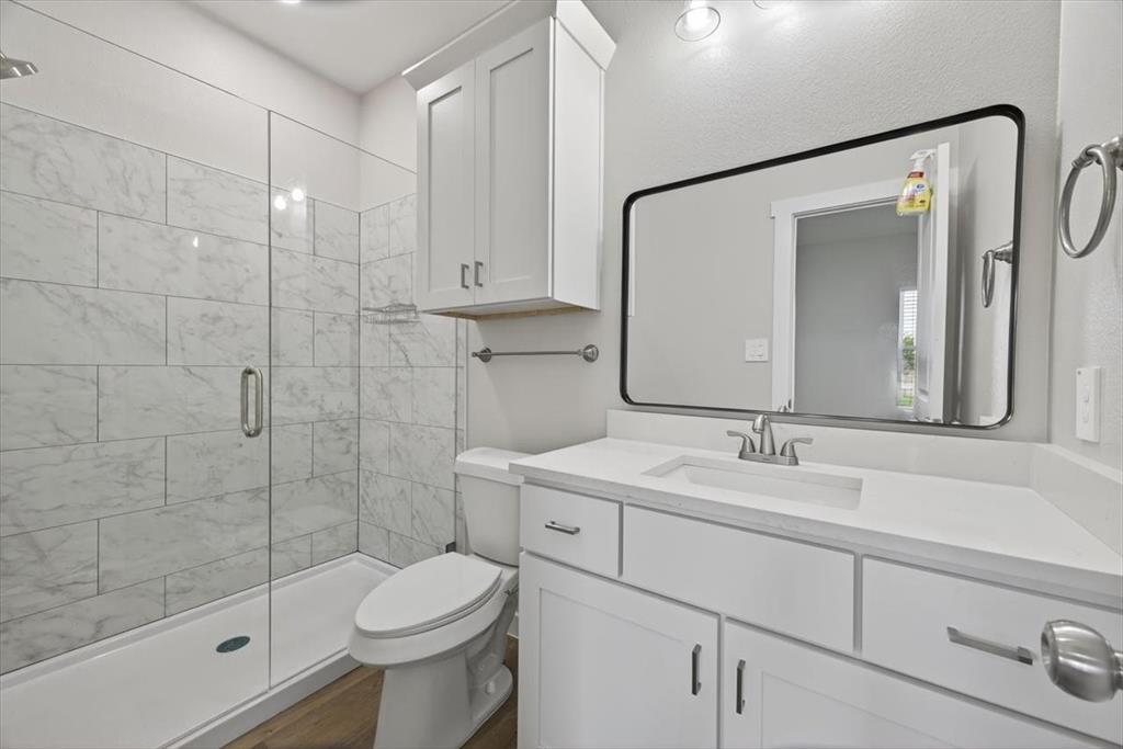 122 Wood Street, Unit A Princeton, TX 75407 - Photo 19 of 29 a bathroom with a sink toilet and shower