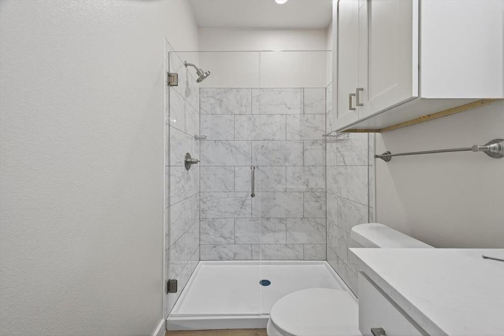 122 Wood Street, Unit A Princeton, TX 75407 - Photo 20 of 29 a bathroom with a toilet and shower