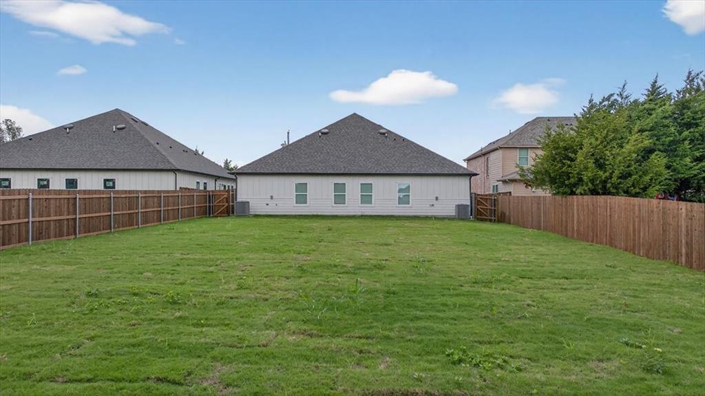 122 Wood Street, Unit A Princeton, TX 75407 - Photo 21 of 29 a view of a house with a backyard