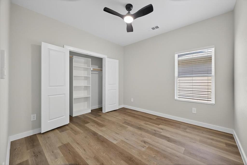 122 Wood Street, Unit A Princeton, TX 75407 - Photo 24 of 29 a view of empty room with wooden floor and ceiling fan