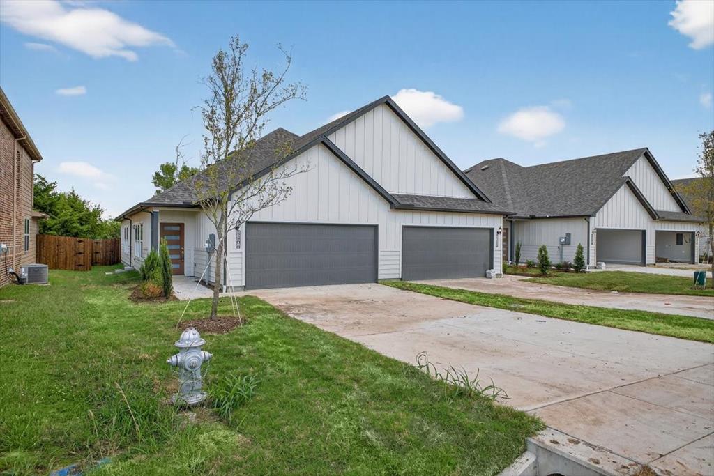 122 Wood Street, Unit A Princeton, TX 75407 - Photo 27 of 29 a front view of a house with a yard and garage