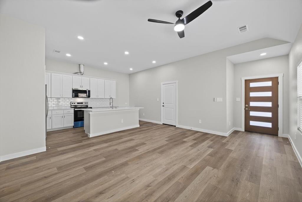 122 Wood Street, Unit A Princeton, TX 75407 - Photo 5 of 29 a view of kitchen with wooden floor and electronic appliances