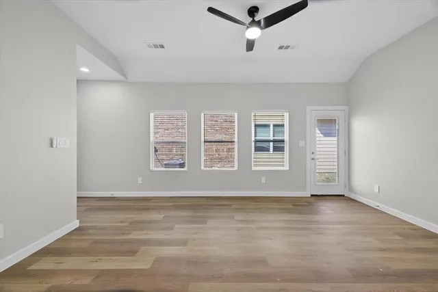 a kitchen with a sink a stove a refrigerator and white cabinets
