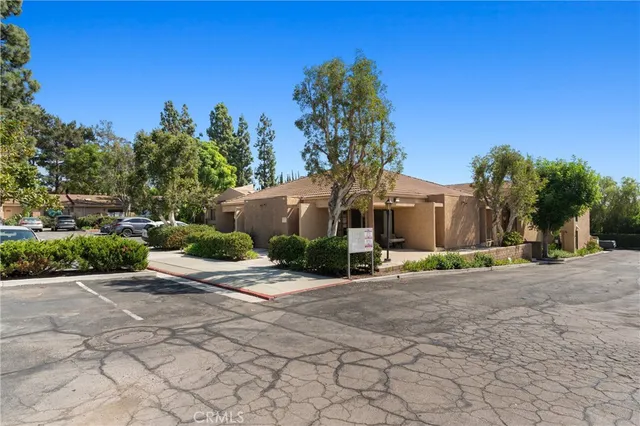 a view of a house with a yard and road