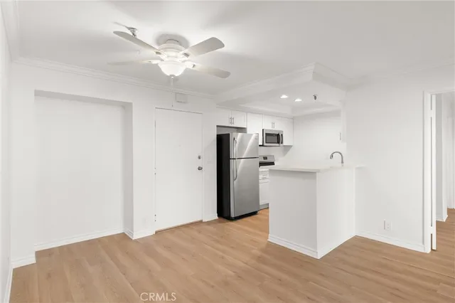 a view of kitchen with refrigerator and cabinets