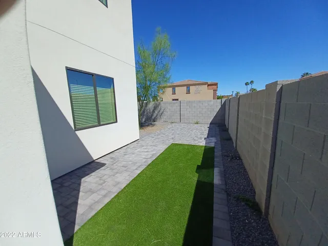 a view of a backyard with chairs
