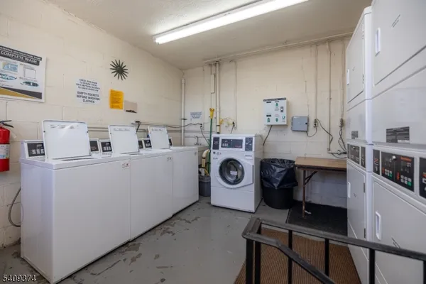 a utility room with sink dryer and washer