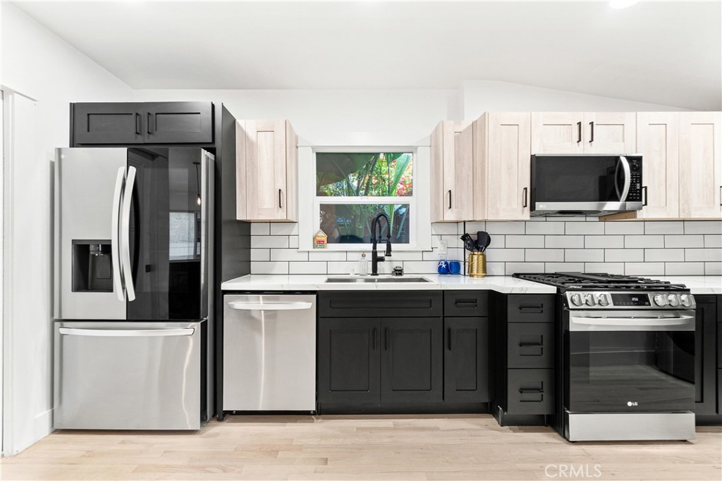 1148 Locust Avenue Long Beach, CA 90813 - Photo 12 of 34 a kitchen with stainless steel appliances a stove sink microwave and refrigerator