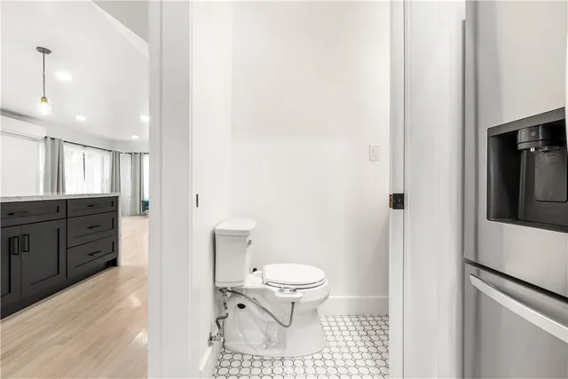 a bathroom with a toilet sink and a mirror
