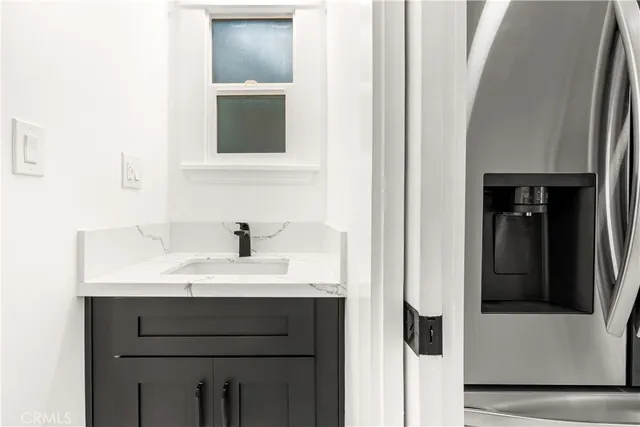 a bathroom with a sink vanity and a mirror