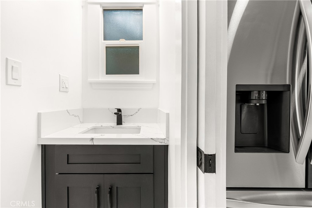1148 Locust Avenue Long Beach, CA 90813 - Photo 14 of 34 a bathroom with a sink vanity and a mirror