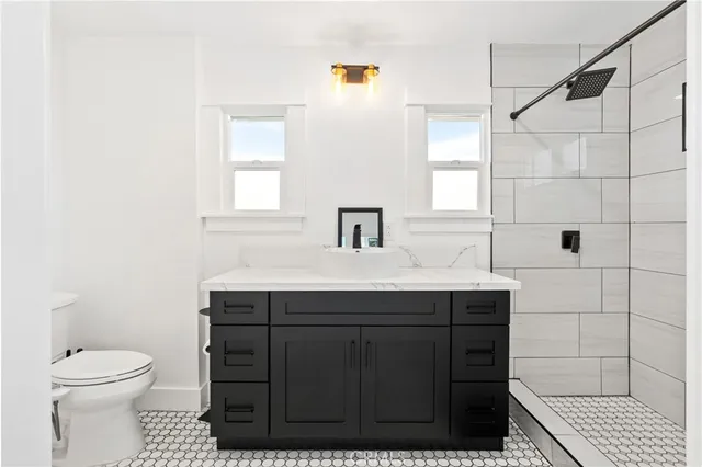 a bathroom with a sink toilet and shower