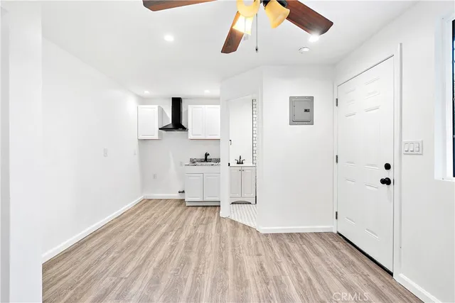 a view of empty room with wooden floor