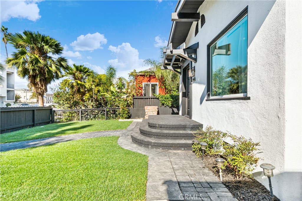 1148 Locust Avenue Long Beach, CA 90813 - Photo 3 of 34 a front view of a house with fountain and garden