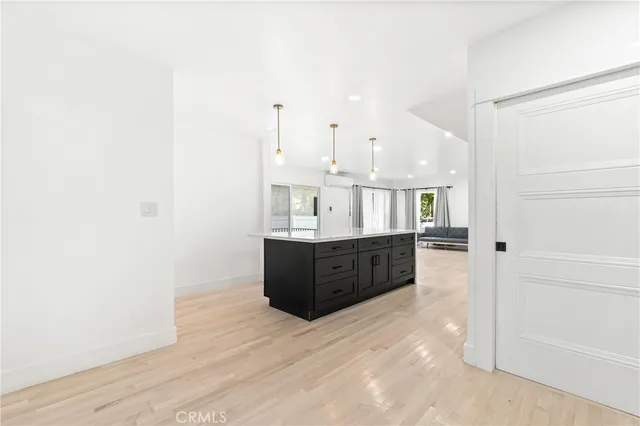 a living room with a dresser and a window
